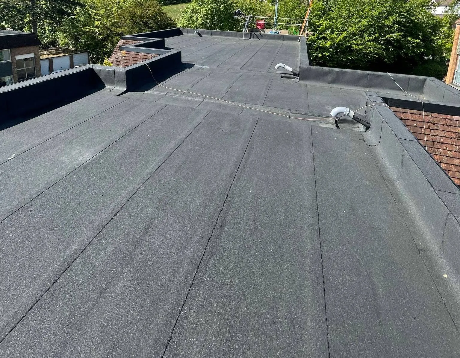 Completed reinforced bituminous membrane flat roof on Guildford flats